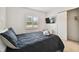 Bedroom with black bedding, ceiling fan, and window shutters at 313 Crystal Beach Ave, Crystal Beach, FL 34681