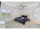 Main bedroom with black bedding, ceiling fan and ensuite bathroom at 313 Crystal Beach Ave, Crystal Beach, FL 34681