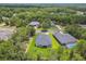 An aerial shot shows the well-maintained home and its expansive surroundings, amidst the trees and community at 6109 Dusk Rose Ln, Brooksville, FL 34601