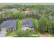 A high angle view showcases the property nestled amidst mature trees in a serene, suburban setting at 6109 Dusk Rose Ln, Brooksville, FL 34601