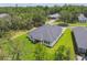 An aerial shot captures the property's well-manicured lawn, backing up to nature and other attractive homes at 6109 Dusk Rose Ln, Brooksville, FL 34601