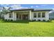Expansive backyard view showcasing a covered patio, perfect for outdoor enjoyment and entertainment at 6109 Dusk Rose Ln, Brooksville, FL 34601