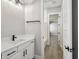 Bathroom features a white vanity with black hardware and a black faucet at 6109 Dusk Rose Ln, Brooksville, FL 34601