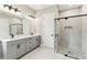Modern bathroom featuring dual sinks and a glass-enclosed shower at 6109 Dusk Rose Ln, Brooksville, FL 34601