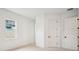 Bright bedroom with plush carpeting, natural light, white walls, and a closet with black hardware at 6109 Dusk Rose Ln, Brooksville, FL 34601