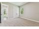 Neutral bedroom with carpet, a double door closet and natural light at 6109 Dusk Rose Ln, Brooksville, FL 34601