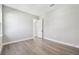Bedroom featuring light gray walls, light wood flooring, white trim, and a window at 6109 Dusk Rose Ln, Brooksville, FL 34601