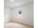 Bright bedroom with neutral carpet, white walls, and a window with a view at 6109 Dusk Rose Ln, Brooksville, FL 34601