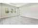 Bedroom showcasing multiple windows, wood floors and neutral walls at 6109 Dusk Rose Ln, Brooksville, FL 34601