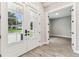 Bright foyer featuring double front doors, wood floors, and transom windows offering a grand entrance at 6109 Dusk Rose Ln, Brooksville, FL 34601
