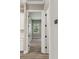 Hallway featuring neutral walls, wood floors, and white trim throughout at 6109 Dusk Rose Ln, Brooksville, FL 34601