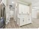Kitchen with white cabinets, stainless steel refrigerator and subway tile backsplash at 6109 Dusk Rose Ln, Brooksville, FL 34601