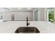 Close up of a kitchen island with a sink and marble countertop at 6109 Dusk Rose Ln, Brooksville, FL 34601