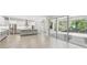Open kitchen featuring white cabinets, gray island, stainless appliances, and a sliding glass door at 6109 Dusk Rose Ln, Brooksville, FL 34601