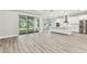 Modern kitchen and living space with stainless steel appliances and an island at 6109 Dusk Rose Ln, Brooksville, FL 34601