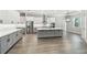 Open-concept kitchen with a large island, stainless steel appliances, and gray and white cabinets at 6109 Dusk Rose Ln, Brooksville, FL 34601