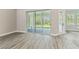 Bright living room showcasing sliding glass doors leading to outdoor patio at 6109 Dusk Rose Ln, Brooksville, FL 34601