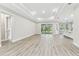 Bright and open living room featuring wood floors, recessed lighting, and a sliding glass door that fills the space with light at 6109 Dusk Rose Ln, Brooksville, FL 34601