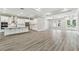 Open concept living space with hardwood floors and ample natural light from plentiful windows at 6109 Dusk Rose Ln, Brooksville, FL 34601