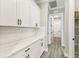 Pantry with subway tile backsplash, white cabinets, and gray tone floors at 6109 Dusk Rose Ln, Brooksville, FL 34601