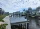 Waterfront home featuring a canal with a private dock, boat lift, and a scenic waterside view at 6428 Driftwood Dr, Hudson, FL 34667