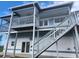 Two-story home features an upper deck, lower patio, and staircases connecting both levels at 6428 Driftwood Dr, Hudson, FL 34667