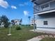 Beautiful home with expansive front yard with lush green grass, a sidewalk, and a view of the ocean at 6428 Driftwood Dr, Hudson, FL 34667
