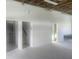 Spacious garage area featuring exposed wooden beams, concrete floors, and bright white wainscoting at 6428 Driftwood Dr, Hudson, FL 34667