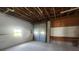Spacious garage with exposed ceiling beams and a convenient roll-up door at 6428 Driftwood Dr, Hudson, FL 34667