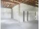 A well-lit garage showcasing exposed ceiling beams and a freshly painted interior at 6428 Driftwood Dr, Hudson, FL 34667