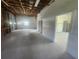 A well-lit garage showcasing exposed ceiling beams and an entrance to the main house at 6428 Driftwood Dr, Hudson, FL 34667