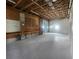 Large garage with a workshop area, shelving, and a sturdy workbench at 6428 Driftwood Dr, Hudson, FL 34667