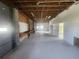 Spacious garage with concrete floor, open rafters, offering a functional workspace at 6428 Driftwood Dr, Hudson, FL 34667
