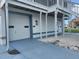 Image displays a three-car garage with white doors, painted in blue trim, and ample parking space at 6428 Driftwood Dr, Hudson, FL 34667