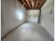 Open garage space with concrete floor and exposed wood beams at 6428 Driftwood Dr, Hudson, FL 34667