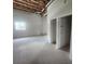 A well-lit garage featuring exposed ceiling beams, concrete floor, and wainscoted walls at 6428 Driftwood Dr, Hudson, FL 34667