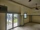Bright living room featuring sliding glass doors offering backyard and waterfront views at 6428 Driftwood Dr, Hudson, FL 34667