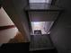 Staircase featuring wood steps and dark carpet at 6428 Driftwood Dr, Hudson, FL 34667