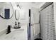 Clean bathroom with double vanity, shower, and black and white decor at 9142 Brooker Dr, New Port Richey, FL 34655