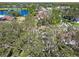 Aerial view of the property and the lake in the background at 9142 Brooker Dr, New Port Richey, FL 34655