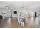 Open concept dining room with farmhouse table and hardwood floors at 9142 Brooker Dr, New Port Richey, FL 34655