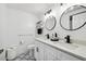 Modern bathroom with double vanity, black accents, and patterned floor at 9142 Brooker Dr, New Port Richey, FL 34655