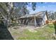 Large backyard with mature trees and a screened porch at 9142 Brooker Dr, New Port Richey, FL 34655