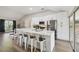 Modern kitchen with white cabinets, stainless steel appliances and a large island at 9142 Brooker Dr, New Port Richey, FL 34655