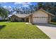 Single-story home with stone accents and a two-car garage at 9142 Brooker Dr, New Port Richey, FL 34655