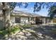 House exterior showcasing backyard, screened porch and large tree at 9142 Brooker Dr, New Port Richey, FL 34655