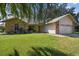 House exterior featuring stone accents and a well-manicured lawn at 9142 Brooker Dr, New Port Richey, FL 34655