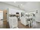 Modern kitchen featuring white cabinets, stainless steel appliances, and an island with seating at 9142 Brooker Dr, New Port Richey, FL 34655