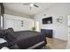 Bright bedroom with a queen bed, wood floors, and built-in shelving at 9142 Brooker Dr, New Port Richey, FL 34655