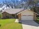 Single-story home with stone facade and two-car garage at 9142 Brooker Dr, New Port Richey, FL 34655